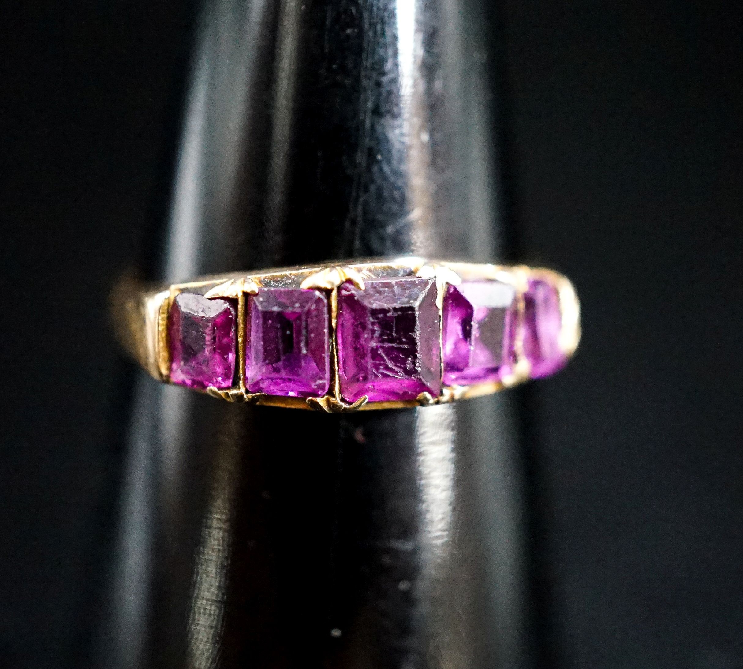 A Victorian 15ct gold and graduated five stone amethyst paste set half hoop ring, size O/P, gross 2.4 grams.